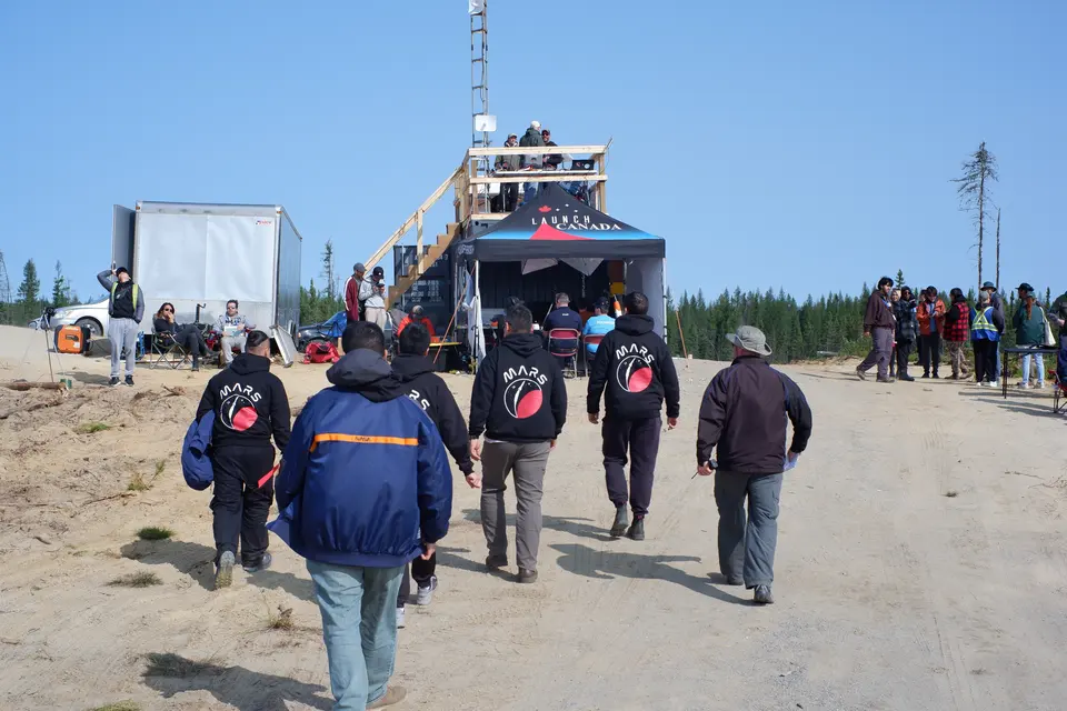 MARS members walking toward the launch-site building