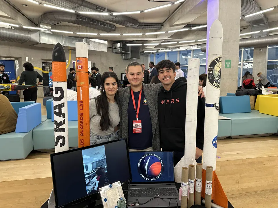 MARS members standing at a display of model rockets