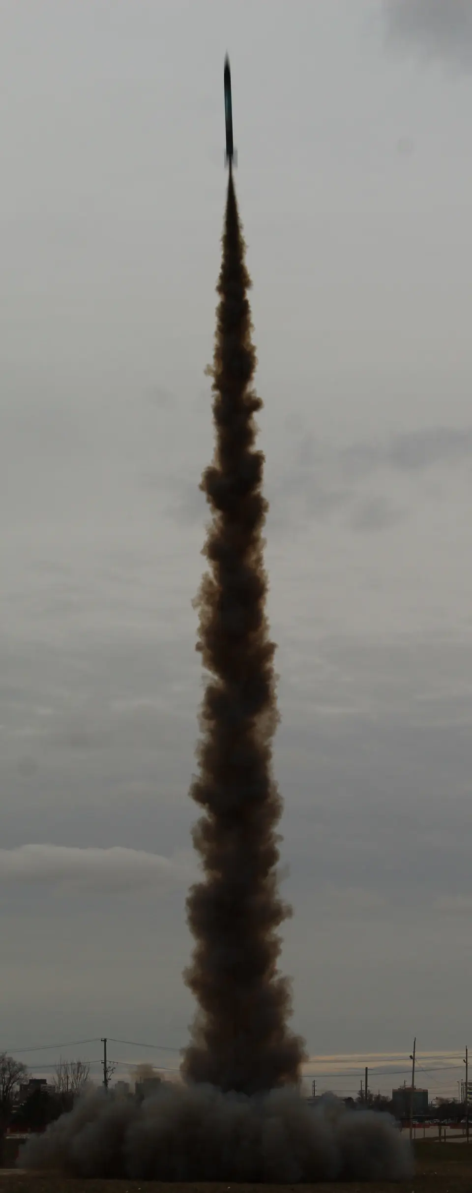 Rocket climbing above a long smoke plume