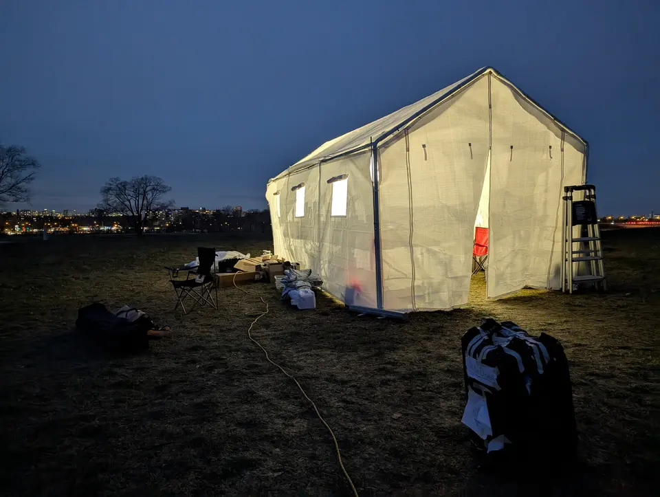 Lit field shelter at dusk