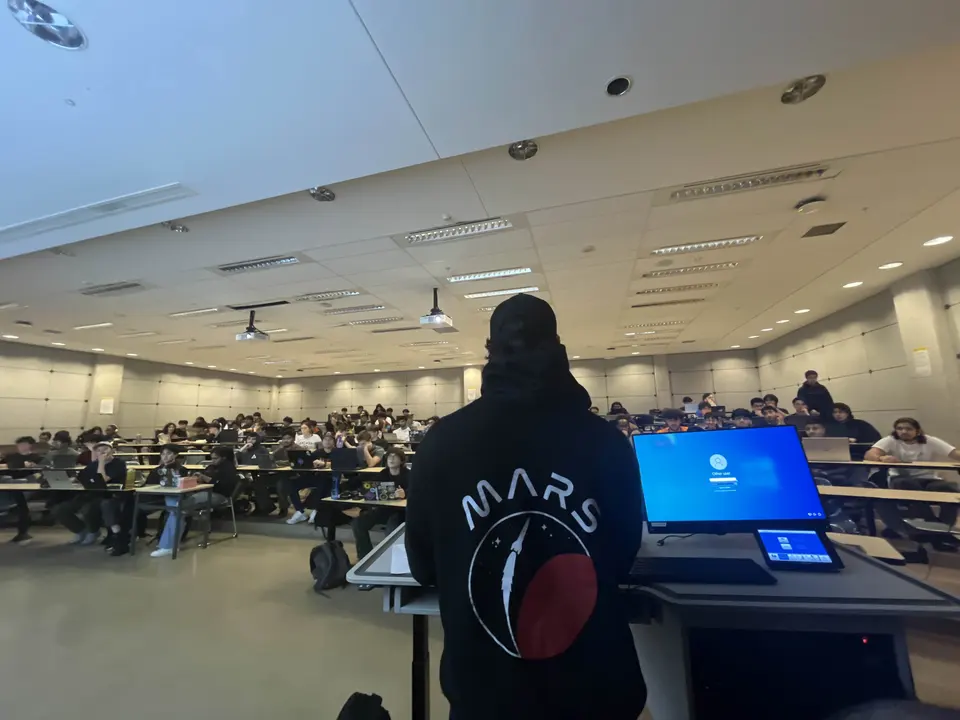 Presenter wearing a MARS hoodie addressing a classroom